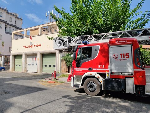 Ostia, Rome, Italy - August 5, 2026, perspective view of the historic building, with the red sign, which houses the Fire Brigade Station, with an operational vehicle ready to intervene.