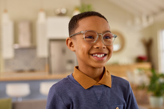 Black smiling african american boy looking away while wearing eyeglasses