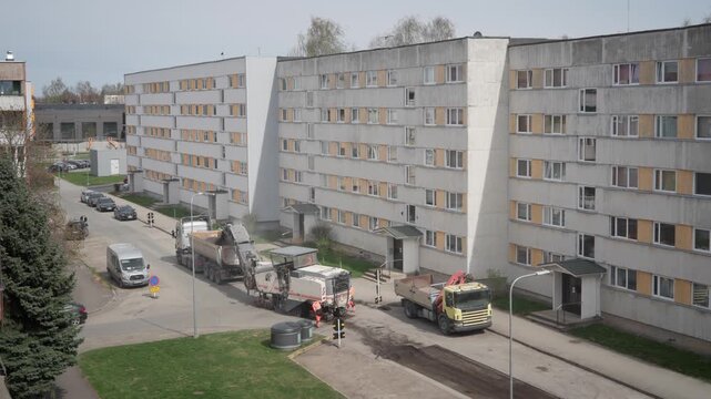 Road construction Estonia asphalt milling machine and workers repairing street