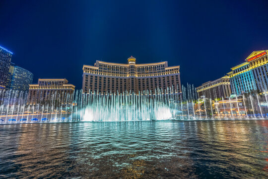Beautiful view of Bellagio fountains and Caesars Palace illuminated at night in Las Vegas. Las Vegas. USA. 
