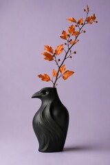 Naklejka premium Black Raven Shaped Ceramic Vase with Orange Autumn Branch