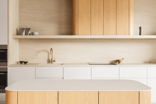 Contemporary beige kitchen interior with oak cabinetry, stone backsplash, minimalist island, open shelving, and elegant architectural design details. 3D Rendering