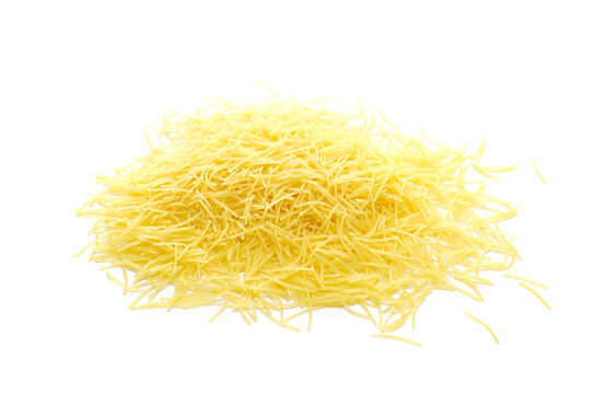 Uncooked durum wheat semolina pasta pile isolated on white background, side view