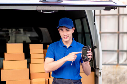 Asian Young Delivery Man Holding Card Reader for Online Payment