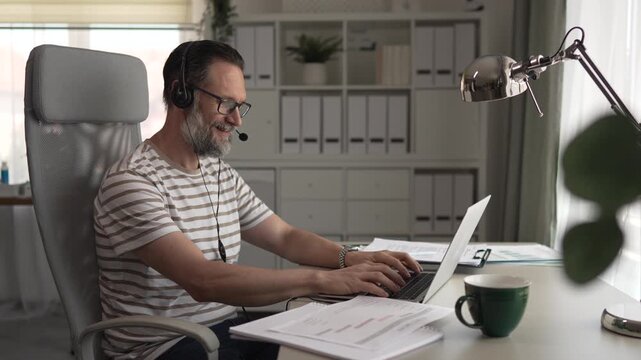 Mature businessman working from home on a videoconference call