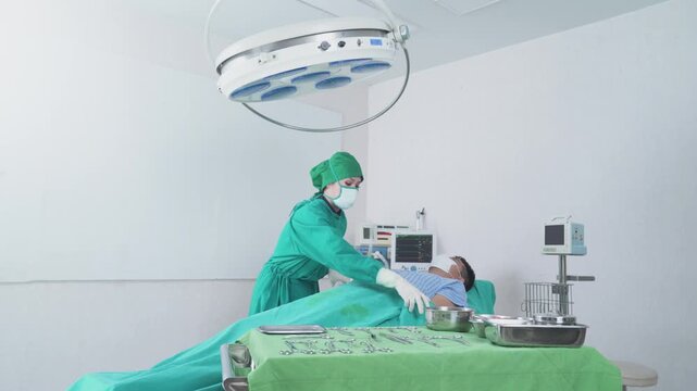 Medical staff preparing and positioning a patient in the operating room prior to surgery.