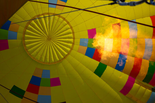 Close up inside view of gas burner flame inflating hot air balloon.
