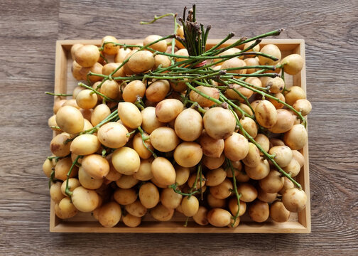 Top view of the bunch of Burmese grape (Mafai) on the plate.