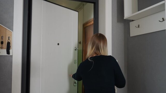 Blonde woman stands at apartment door while neighbor arrives with moving box, polite handoff in narrow hallway with shelves and key hooks, cozy modern foyer atmosphere, subtle relief and neighborly
