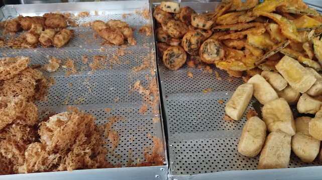 Thai crispy deep-fried appetizers including tofu and taro snacks