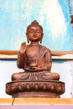 Bronze Buddha statue sculpture sitting in lotus pose with blessing gesture in Hampi, India. Close up of traditional religious art handicraft, spiritual decoration object, sacred deity.