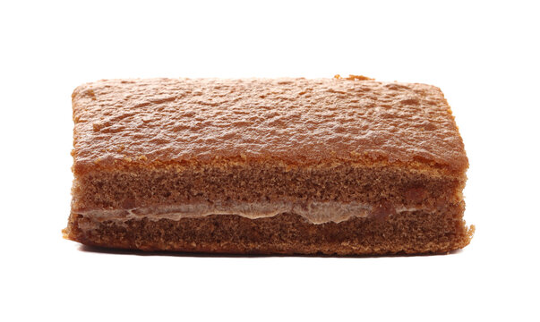 Sponge cake with chocolate flavour cream isolated on white background, side view