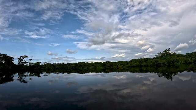 Wide Flooded Amazon Rainforest Lagoon in Ecuador with Calm Dark Water, Cloud Reflections, Dense Forest Shoreline, Tropical Wetland Habitat and Remote Jungle Wilderness Landscape