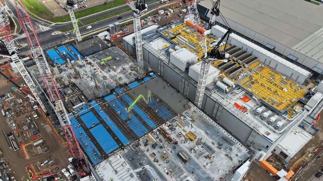 Large data centre industrial facility building constructing process aerial view