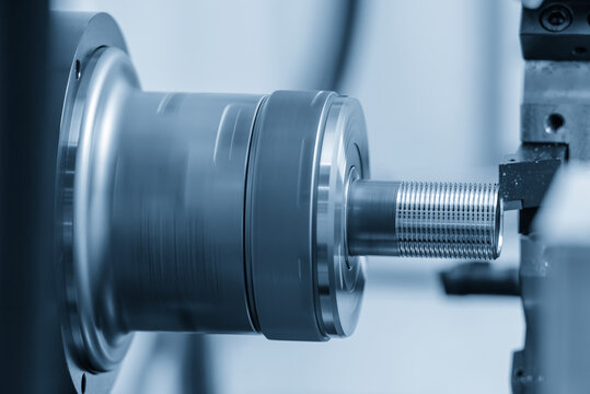 Thread making process on tube end using CNC lathe machine in blue tone lighting