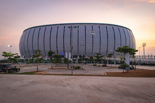 Jakarta, Indonesia - August 10, 2026: Jakarta International Stadium (JIS) in North Jakarta, featuring its distinctive modern facade and surrounding urban landscape at sunset.