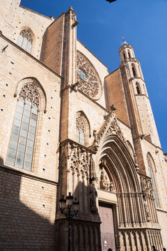 Ancient medieval gothic cathedral building facade with stone carved entrance portal close up.
