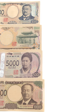 Top view of Japanese yen banknotes front sides stacked vertically: new 1,000 yen, rare 2,000 yen, new 5,000 yen, and new 10,000 yen (Series E). Isolated on white background.