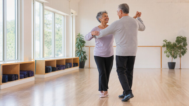 Senior couple dancing together in bright studio, joyful moments shared during dance session. Seniors engage in fun dance activities while enjoying vibrant natural light filtering through windows.