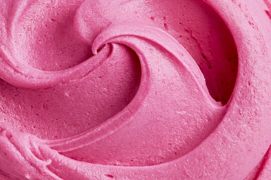 Close up of raspberry mousse swirl texture in rich pink color, showcasing creamy consistency and smooth surface details for culinary applications and dessert presentations