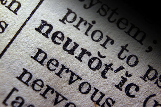 Word neurotic  printed on dictionary page, macro close up.