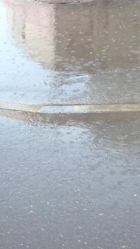 Rain water collects on the street during a light rain at a city intersection