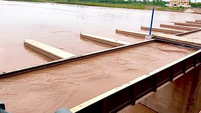 Muddy River Water Flowing Through Barrage Gates Infrastructure