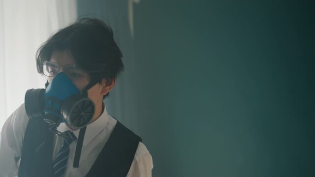 Masked young man stares through respirator, frontal closeups with tailored vest and tie, soft window light sculpts features, ambiguous mood blending anonymity and intensity, frames imply performer,