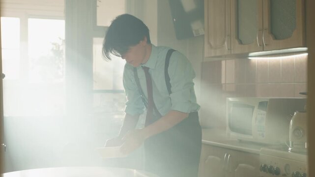 Young man in sunlit kitchen leaning over table inspecting powder, warm light shafts cut through haze, retro cabinets and appliances, suspenders and loosened tie, cinematic grain, contemplative mood,