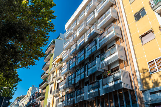 Residential apartment building facade in Bari, Italy with modern balconies and glass railings on sunny day, urban real estate and city living concept