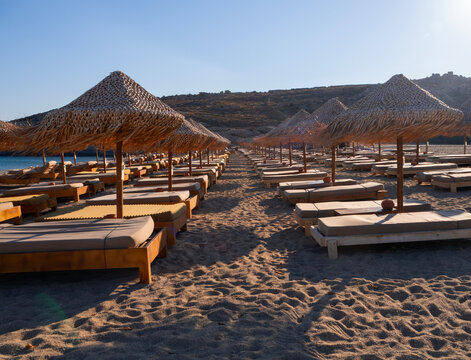 Palm beach umbrellas on the beach of Mykonos Island in Greece
