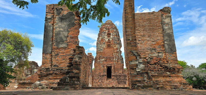 The "Viharn Klaep" (or Viharn Maha Udom) with a clear sky as a backdrop, is part of the important ancient monuments within Wat Mahathat, Ayutthaya Province, a World Heritage Site over 600 years old.
