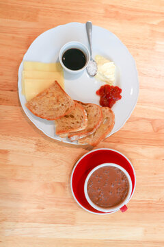 sourdough bread or bread or whole wheat bread or sliced bread with cranberry sauce ,honey and cheese served with hot cocoa