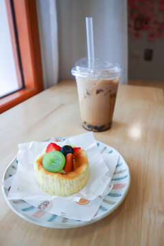 cheesecake with fruit topping or basque cheesecake with fruit topping and iced tea or milk tea or bubble tea