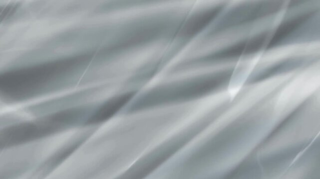 Abstract grey silk waves motion graphic moving across frame creating fluid texture for elegant background.
