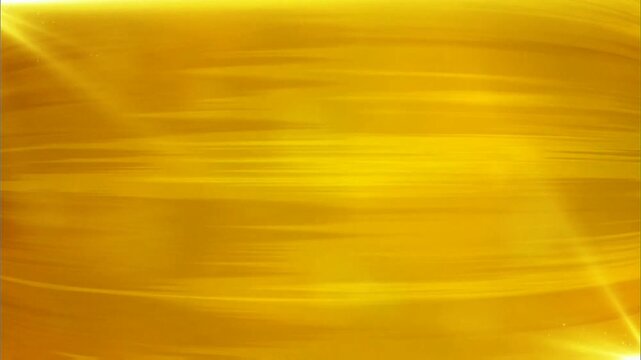 Flowing golden yellow surface with soft horizontal motion streaks, warm radiant glow and subtle light flares create smooth luxurious luminous texture across full frame.