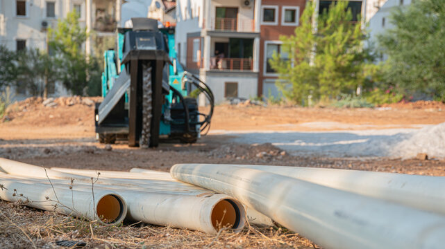 Plastic Utility Pipes at Construction Site with Wheel Saw Trencher