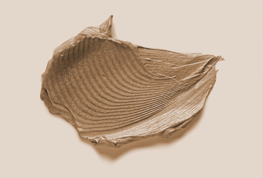 Clay mask texture smudge background. Brown cosmetic mud cream swatch closeup. Skincare beauty product sample stroke top view