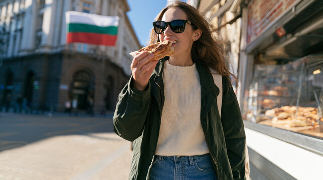 Woman Eating Traditional Bulgarian Banitsa Pastry on Sunny Street in Sofia