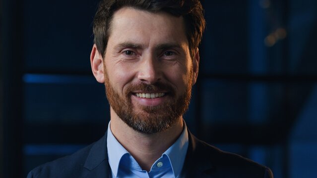 Portrait happy Caucasian middle-aged business man smiling looking at camera at dark office optimistic satisfied male worker businessman entrepreneur owner leader manager smile in evening night indoor