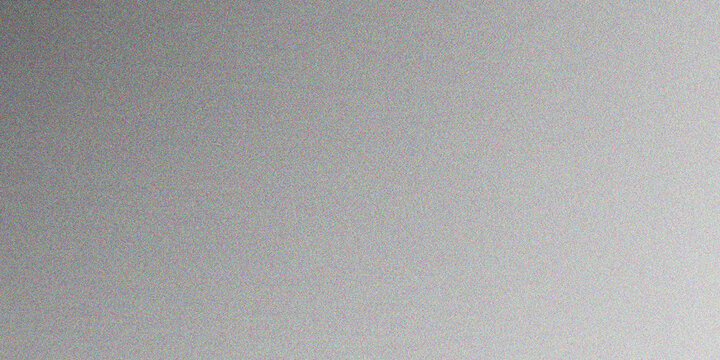 Close up of a textured gray brick wall with subtle light and shadow variations
