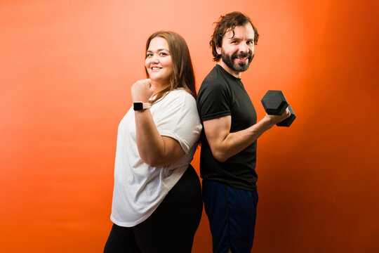 Happy couple starting a fitness journey together, achieving personal health and weight loss goals with determination