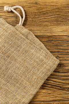 Simple burlap bag on wooden surface