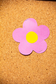 Flower made of paper on a cork board in a workspace