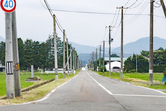 Quiet Japanese Countryside Asphalt Road with Utility Poles and Mountain View