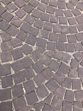 European Weathered old grey cobblestone paving stones texture blocks masonry background