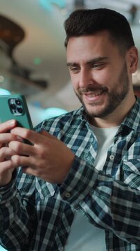 Happy smiling Caucasian business man guy using mobile phone social media scrolling online application smile cheerful male businessman browsing smartphone enjoying chatting web device in shopping mall