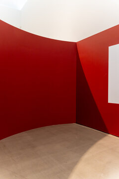 Abstract minimalist architecture featuring striking red walls, geometric shadows, and clean copy space. Ideal for modern B2B conceptual backgrounds.