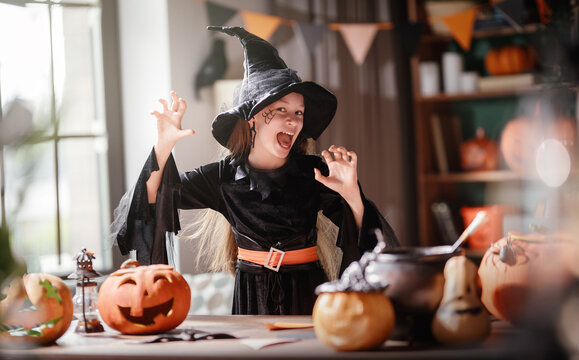 Happy Child in Witch Costume Celebrating Halloween at Home