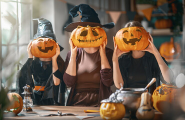 Obraz premium Happy Family Celebrating Halloween with Pumpkin Jack-O-Lanterns